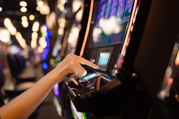 A young woman relaxing with her phone while dynamic casino elements float around her, illustrating the smooth mobile experience offered by the KU9 app.