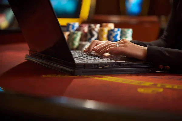 A glowing roulette wheel with cascading chips, symbolizing the engaging live and instant-win games available on KU9.