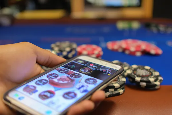 A confident dealer surrounded by casino chips inviting players to access their KU9 account, reflecting quick and easy login options.
